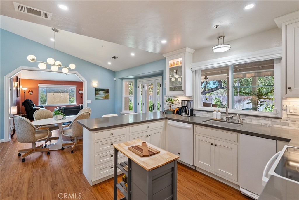 7215 San Gabriel Road Atascadero, CA 93422 - Photo 21 of 74 a kitchen with a sink stove and wooden floor