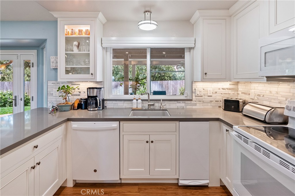 7215 San Gabriel Road Atascadero, CA 93422 - Photo 23 of 74 a kitchen with stainless steel appliances granite countertop a sink a stove a counter space and a window