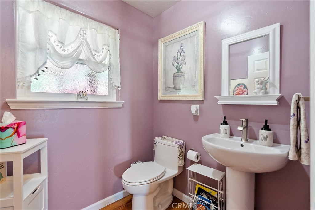 7215 San Gabriel Road Atascadero, CA 93422 - Photo 29 of 74 a bathroom with a sink and mirror with toilet