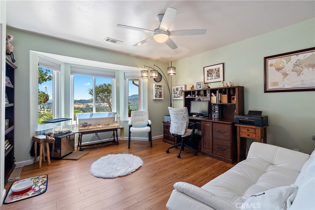 7215 San Gabriel Road Atascadero, CA 93422 - Photo 30 of 74 a living room with furniture a piano and a bookshelf