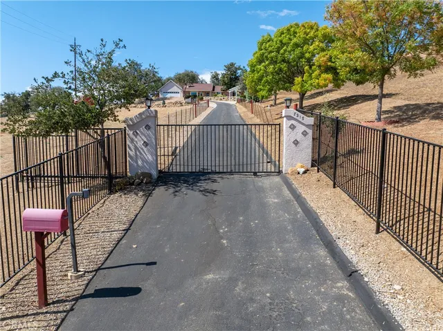 a front view of a house with yard and parking