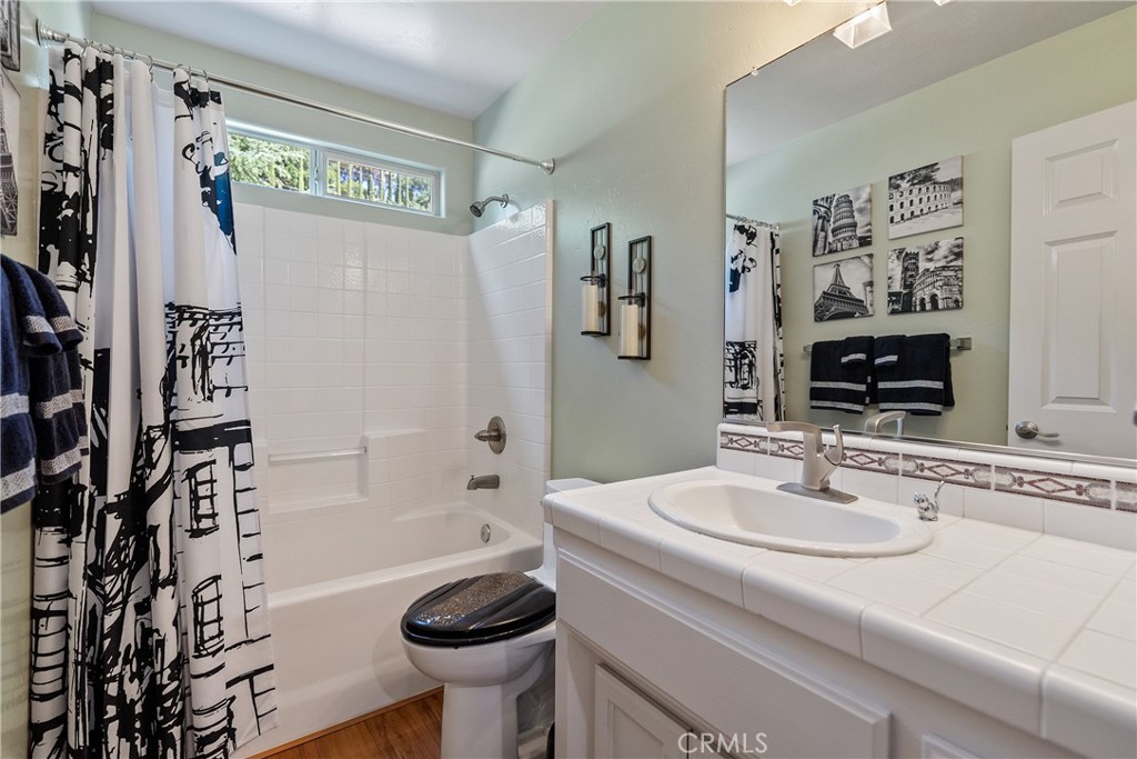 7215 San Gabriel Road Atascadero, CA 93422 - Photo 32 of 74 a bathroom with a sink toilet and shower