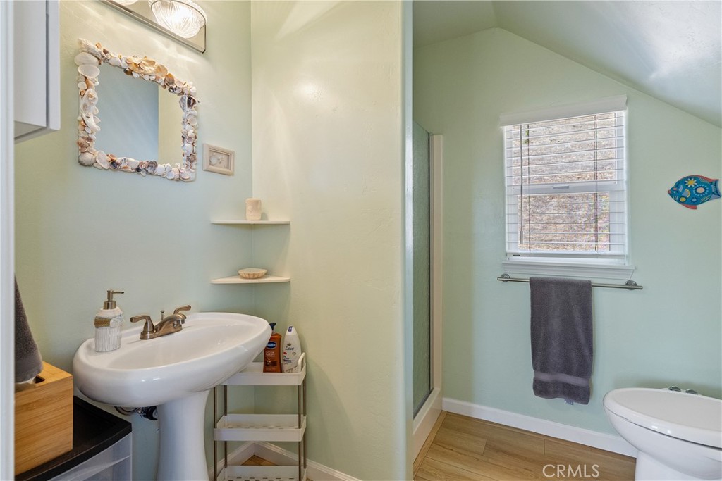 7215 San Gabriel Road Atascadero, CA 93422 - Photo 48 of 74 a bathroom with a sink a toilet and a mirror