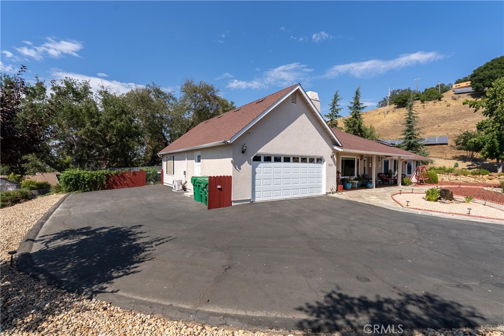 7215 San Gabriel Road Atascadero, CA 93422 - Photo 52 of 74 a front view of a house with a yard and garage