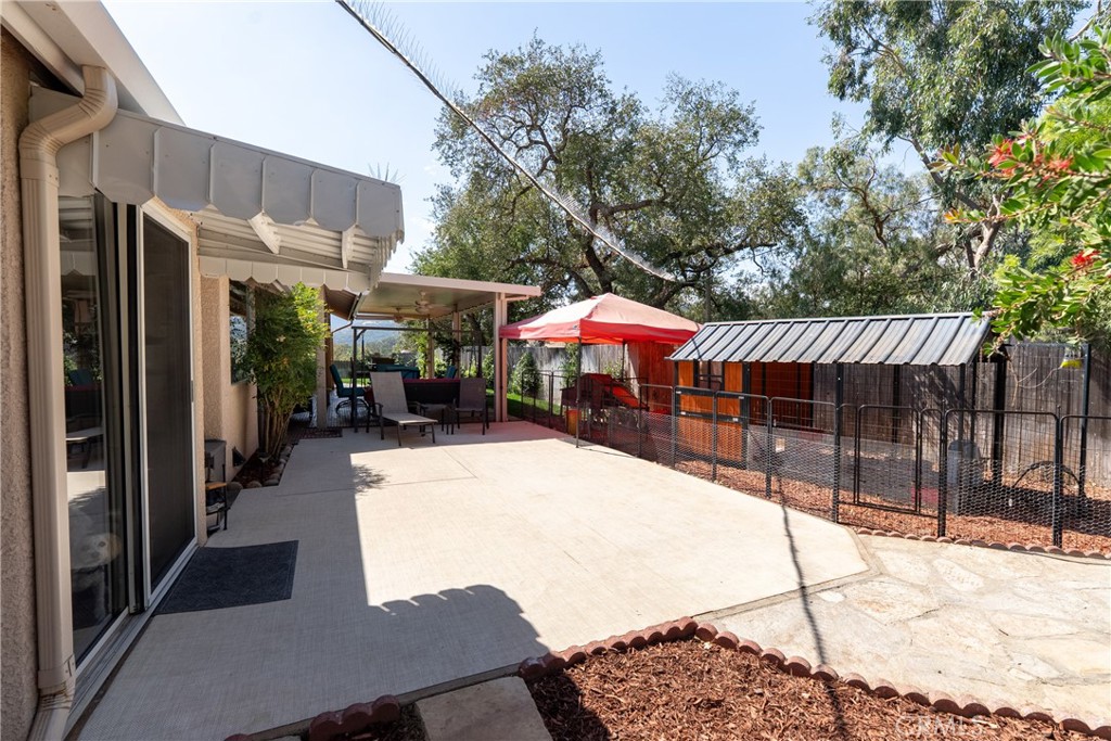 7215 San Gabriel Road Atascadero, CA 93422 - Photo 55 of 74 a view of a patio with table and chairs with wooden floor and fence