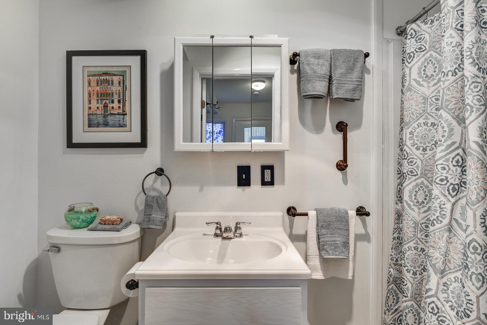12928 Coppermine Road Union Bridge, MD 21791 - Photo 18 of 38 a bathroom with a toilet sink and mirror