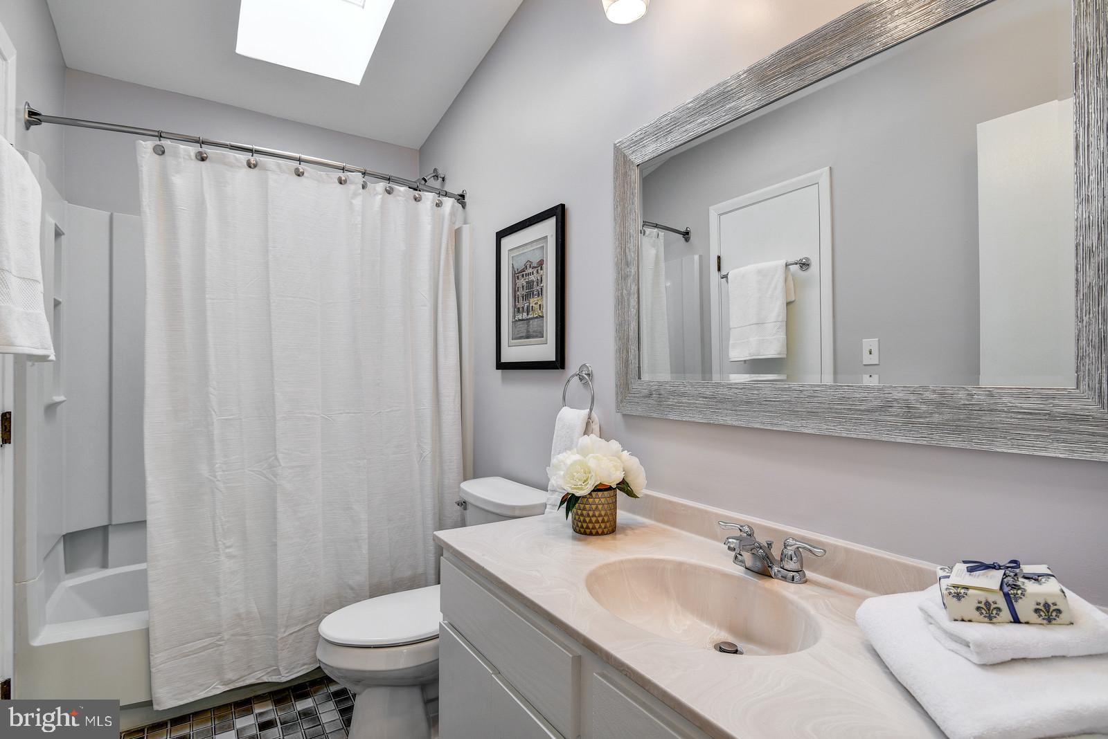 12928 Coppermine Road Union Bridge, MD 21791 - Photo 28 of 38 a bathroom with a sink toilet and mirror