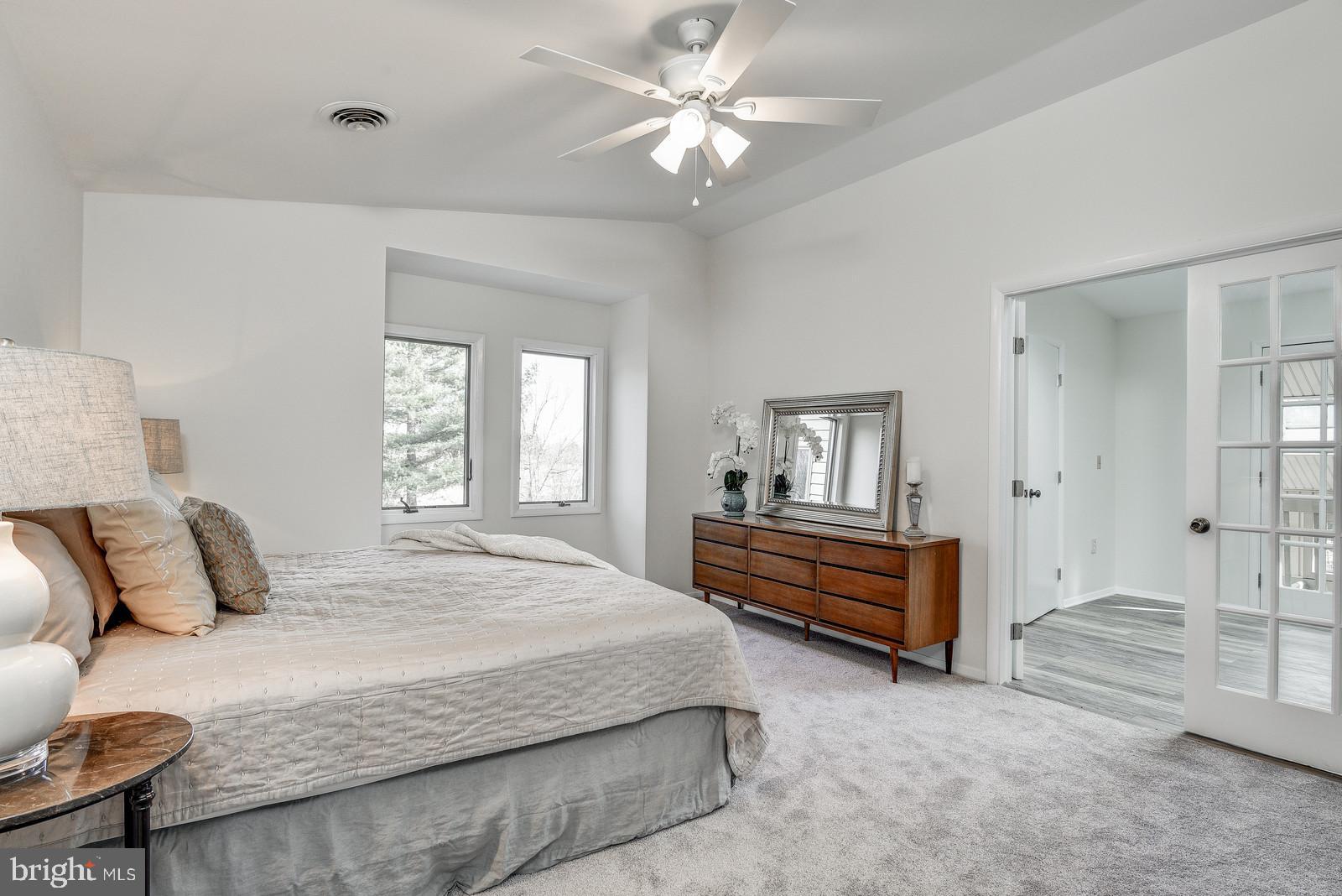 12928 Coppermine Road Union Bridge, MD 21791 - Photo 29 of 38 a bedroom with a bed and a chandelier