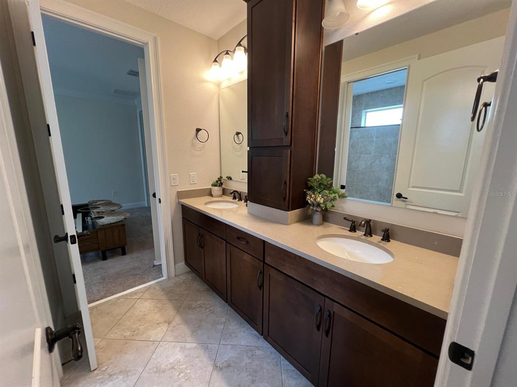 12927 Canopy Woods Way Winter Garden, FL 34787 - Photo 23 of 41 a spacious bathroom with a double vanity sink a double vanity and a mirror