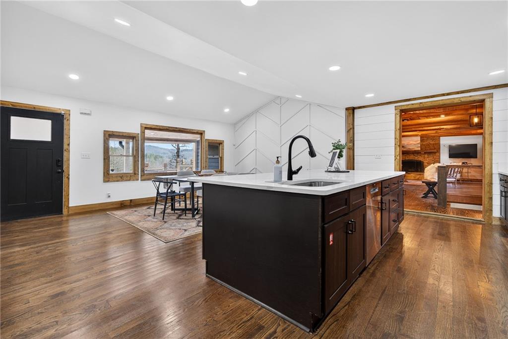 11 Collins Hollow Road Morganton, GA 30560 - Photo 14 of 55 a kitchen with counter top space and a dining table with wooden floor