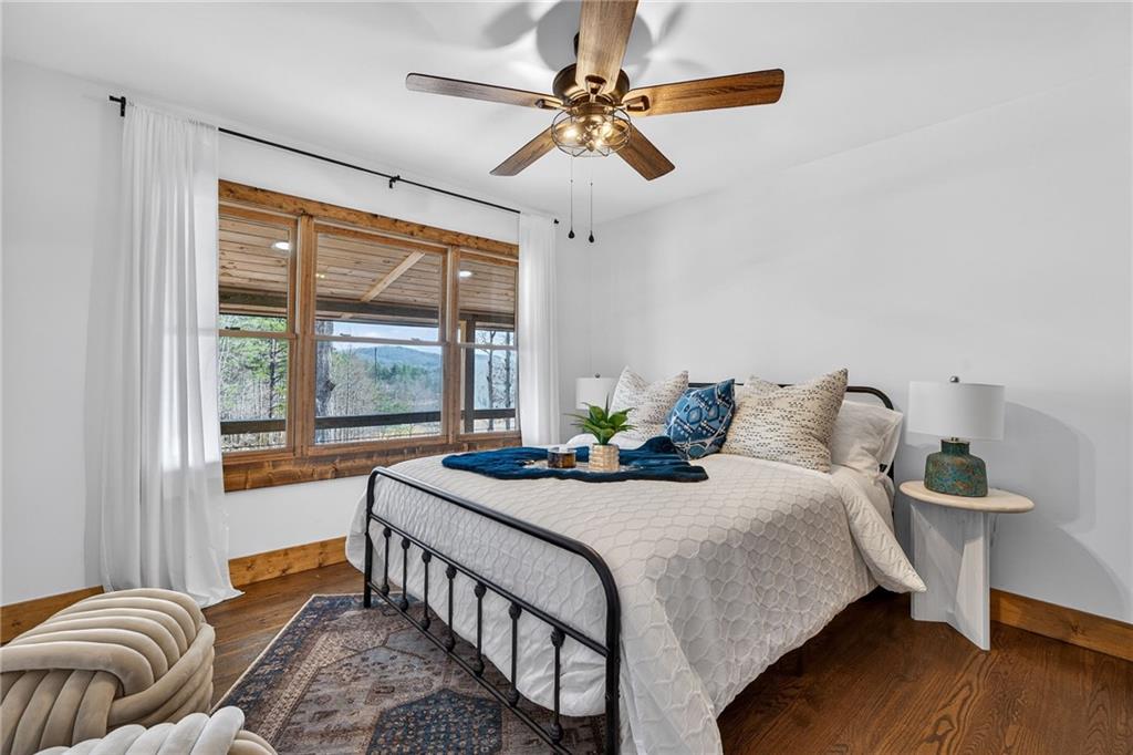 11 Collins Hollow Road Morganton, GA 30560 - Photo 30 of 55 a bedroom with a bed and a chandelier