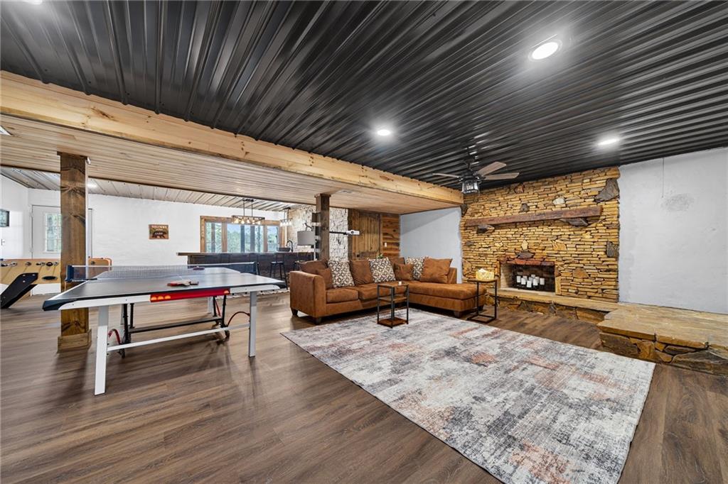 11 Collins Hollow Road Morganton, GA 30560 - Photo 36 of 55 a living room with furniture pool table wooden floor and a fireplace
