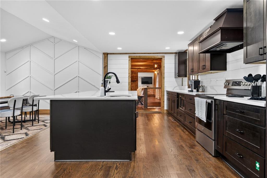 11 Collins Hollow Road Morganton, GA 30560 - Photo 10 of 55 a kitchen with stainless steel appliances a sink a stove a refrigerator cabinets and a dining table