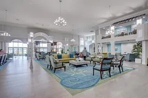 a living room with lots of furniture and a chandelier