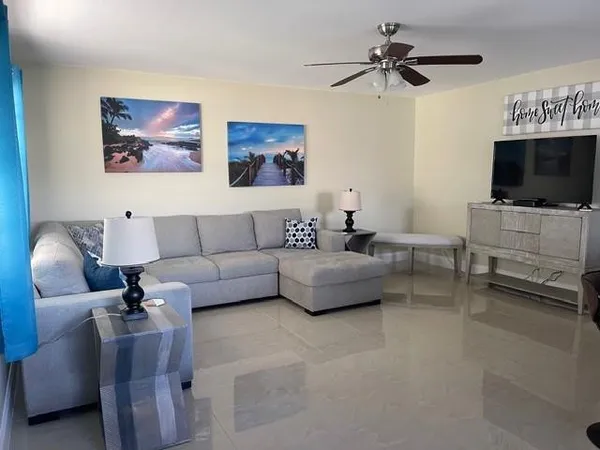 a living room with furniture and a flat screen tv
