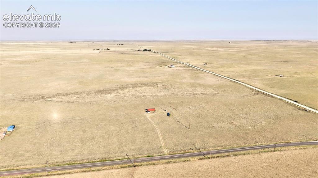 9670 Boone Road Yoder, CO 80864 - Photo 9 of 18 Expansive rural land featuring a paved road and clear skies