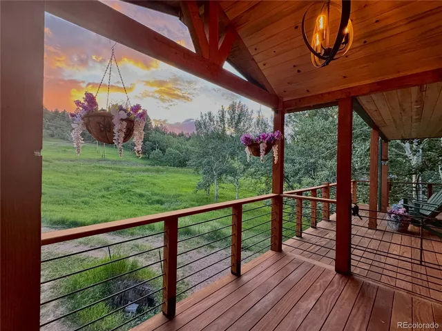 a view of balcony with wooden floor and fence