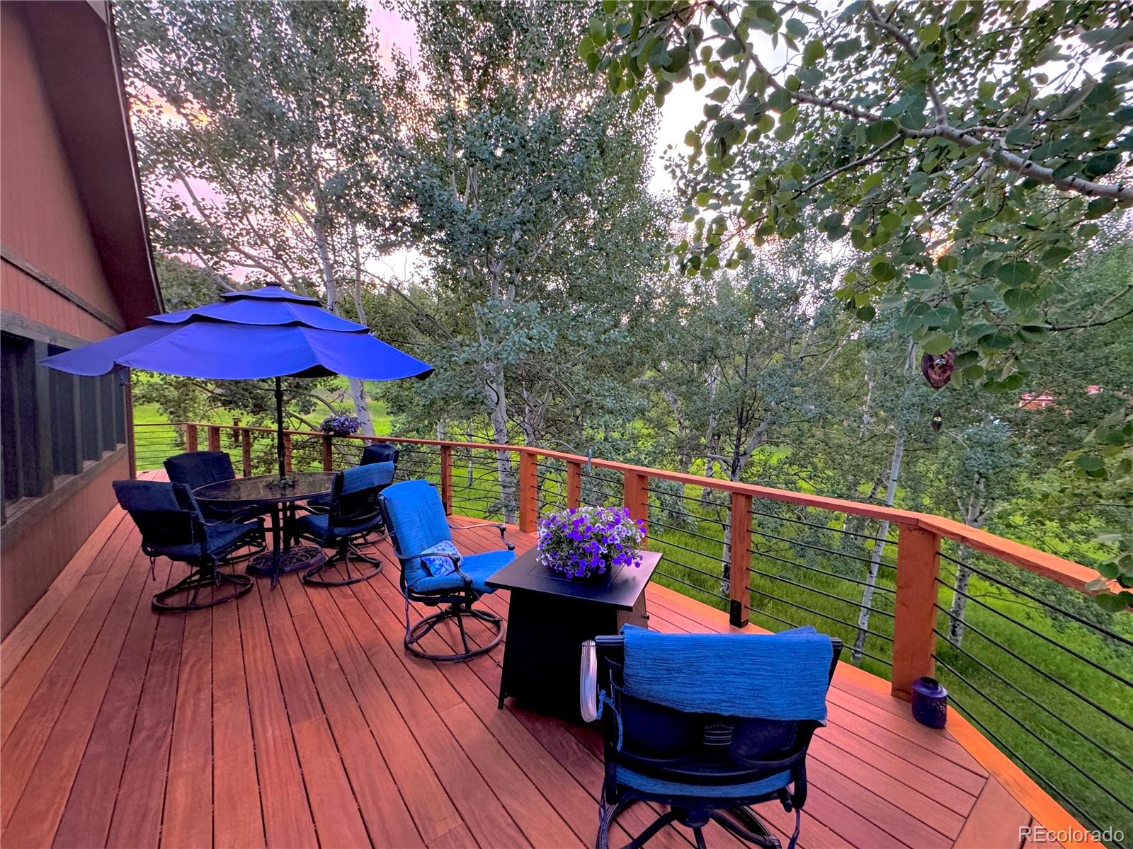 20033 Silver Ranch Road Conifer, CO 80433 - Photo 12 of 43 an outdoor sitting area with furniture and wooden deck