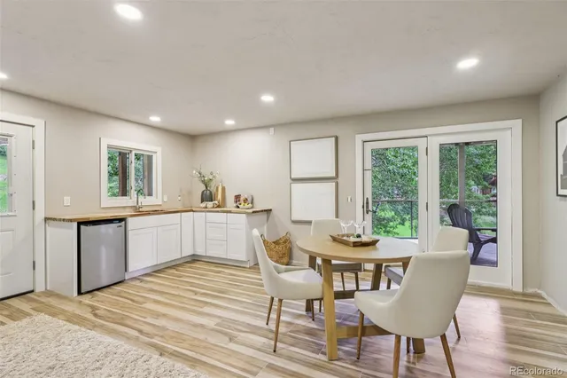 a view of a house with a yard and potted plants