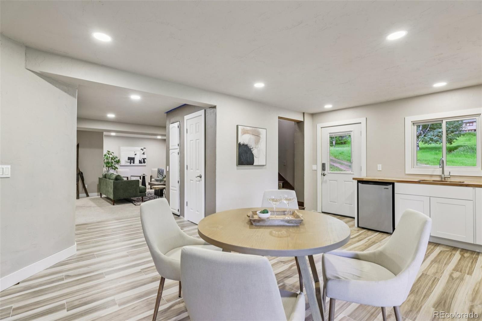 20033 Silver Ranch Road Conifer, CO 80433 - Photo 27 of 43 a view of a dining room with furniture and wooden floor