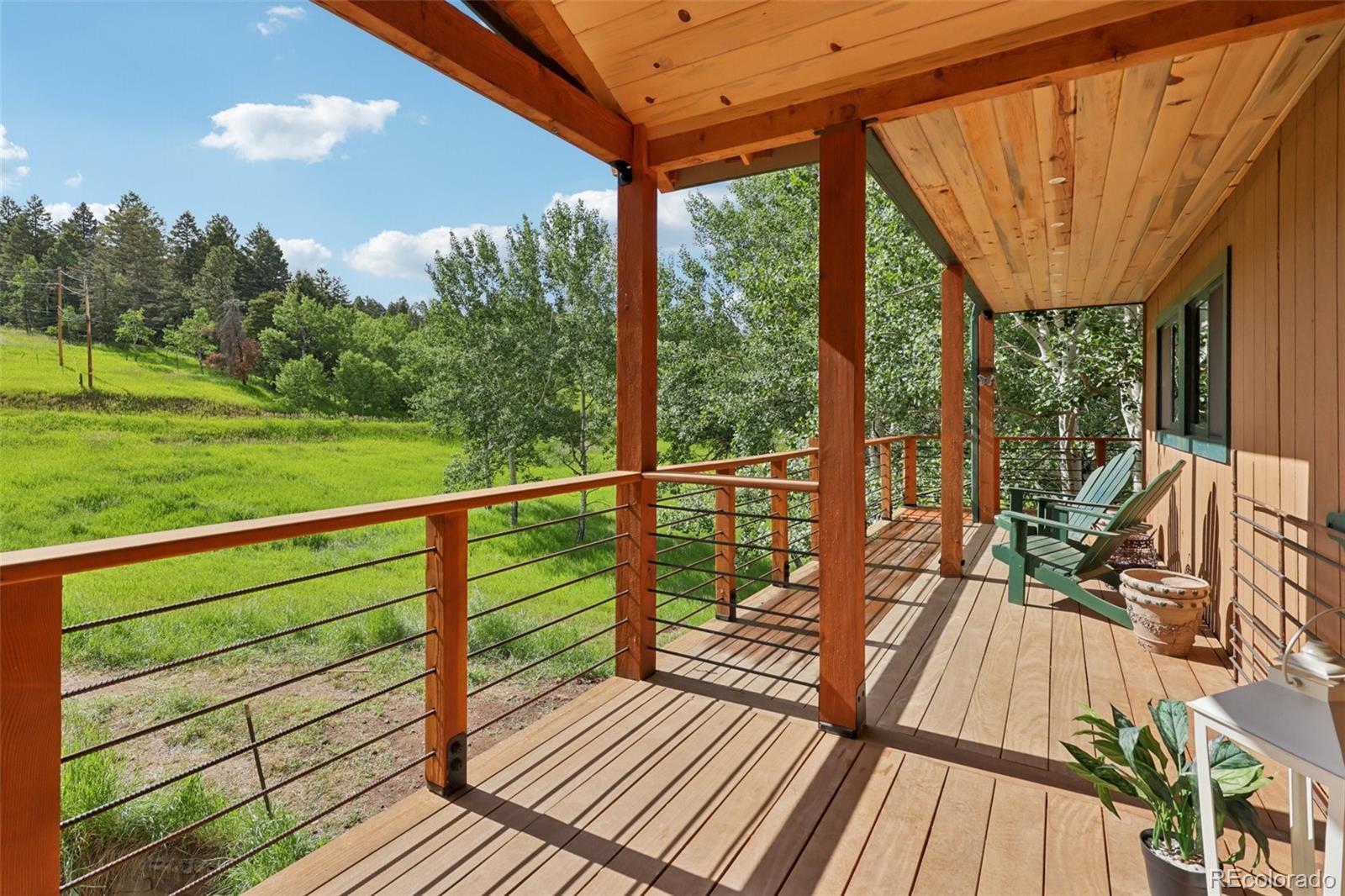 20033 Silver Ranch Road Conifer, CO 80433 - Photo 4 of 43 a view of balcony with wooden floor and fence