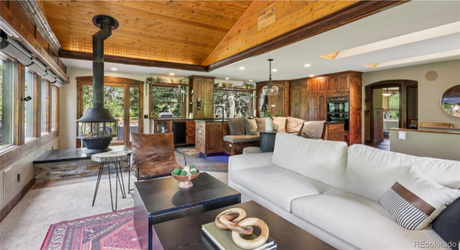 20033 Silver Ranch Road Conifer, CO 80433 - Photo 5 of 43 a living room with furniture and a large window