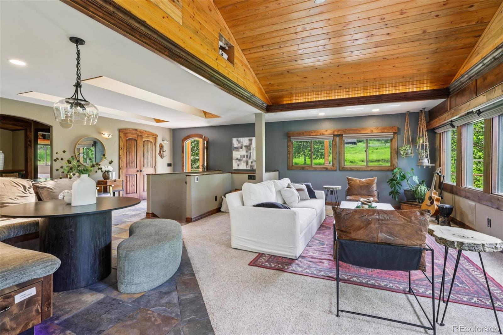 20033 Silver Ranch Road Conifer, CO 80433 - Photo 6 of 43 a living room with furniture and a large window