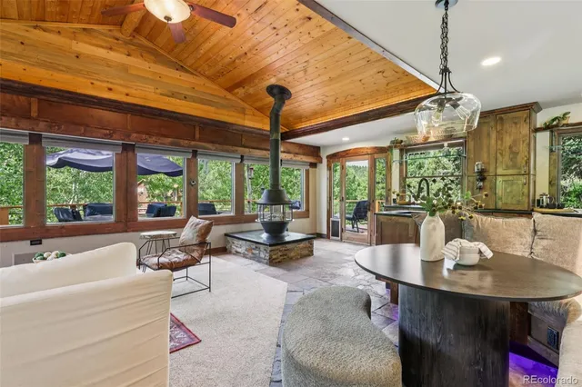 an outdoor sitting area with furniture and wooden deck