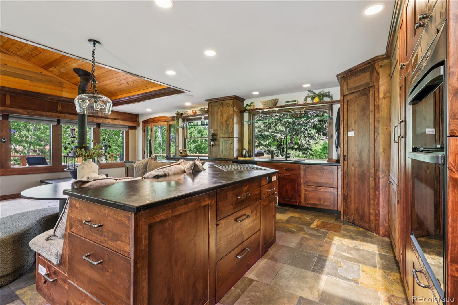20033 Silver Ranch Road Conifer, CO 80433 - Photo 10 of 43 a kitchen with a sink and a refrigerator