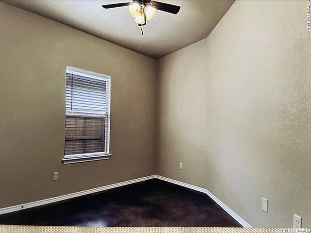 a bathroom with a granite countertop sink and a toilet