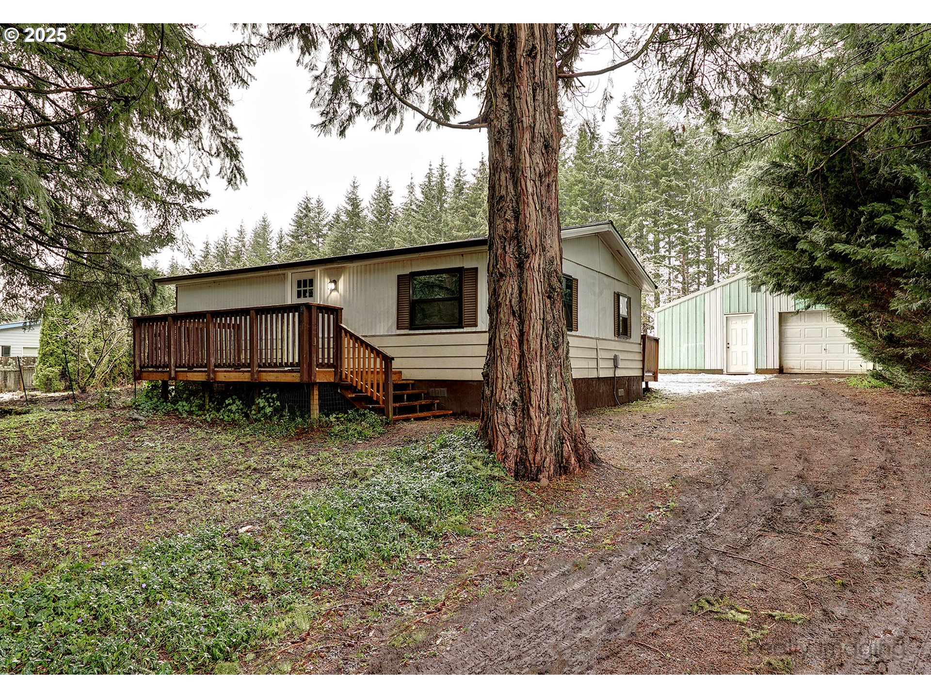 25581 South Holman Road Estacada, OR 97023 - Photo 1 of 14 a backyard of a house with wooden fence and large trees