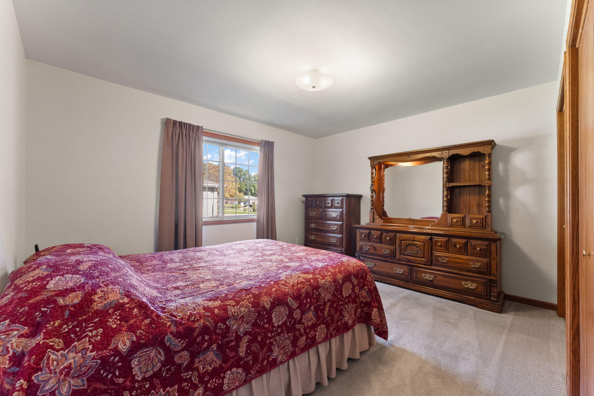 2034 Texas Street Chesterton, IN 46304 - Photo 11 of 22 a bedroom with a bed and dresser with mirror