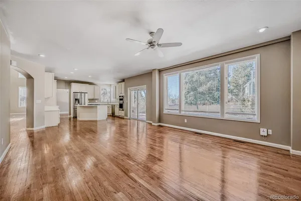 a view of empty room with wooden floor and window