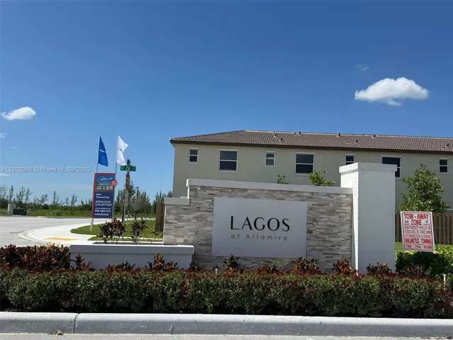 a view of a house with a yard and potted plants