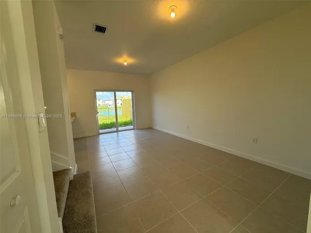 a kitchen with stainless steel appliances granite countertop a refrigerator a stove and a sink