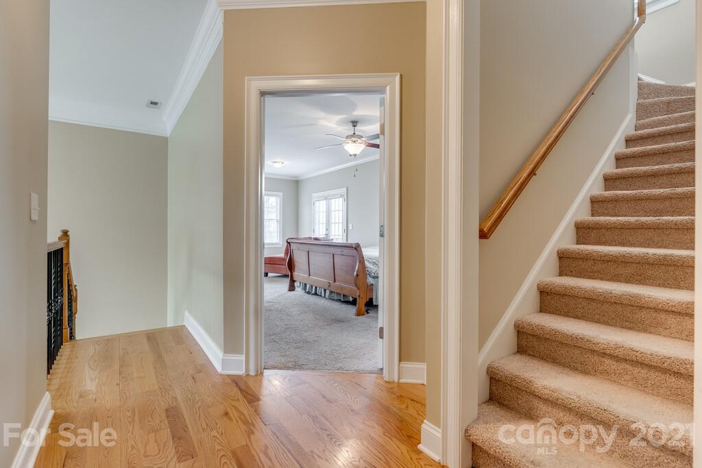 11155 Turtle Bay Court Tega Cay, SC 29708 - Photo 12 of 36 a view of a hallway with wooden floor and workspace