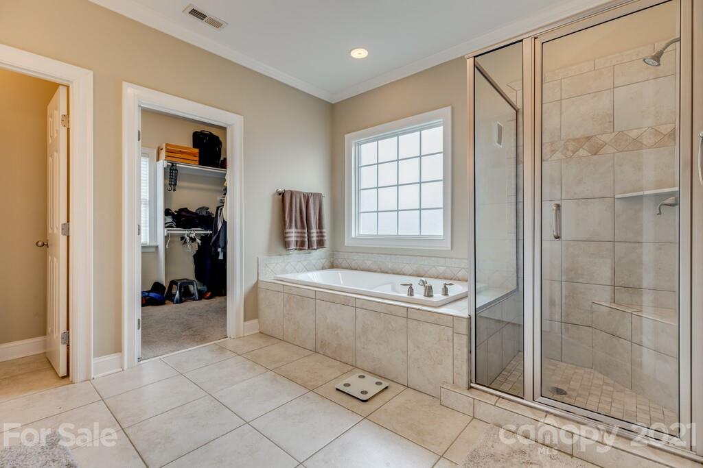 11155 Turtle Bay Court Tega Cay, SC 29708 - Photo 14 of 36 a spacious bathroom with a tub and shower