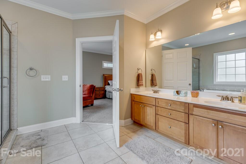 11155 Turtle Bay Court Tega Cay, SC 29708 - Photo 15 of 36 a en suite bathroom with double sink and mirror