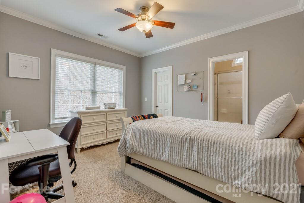 11155 Turtle Bay Court Tega Cay, SC 29708 - Photo 17 of 36 a bedroom with a bed and a chandelier