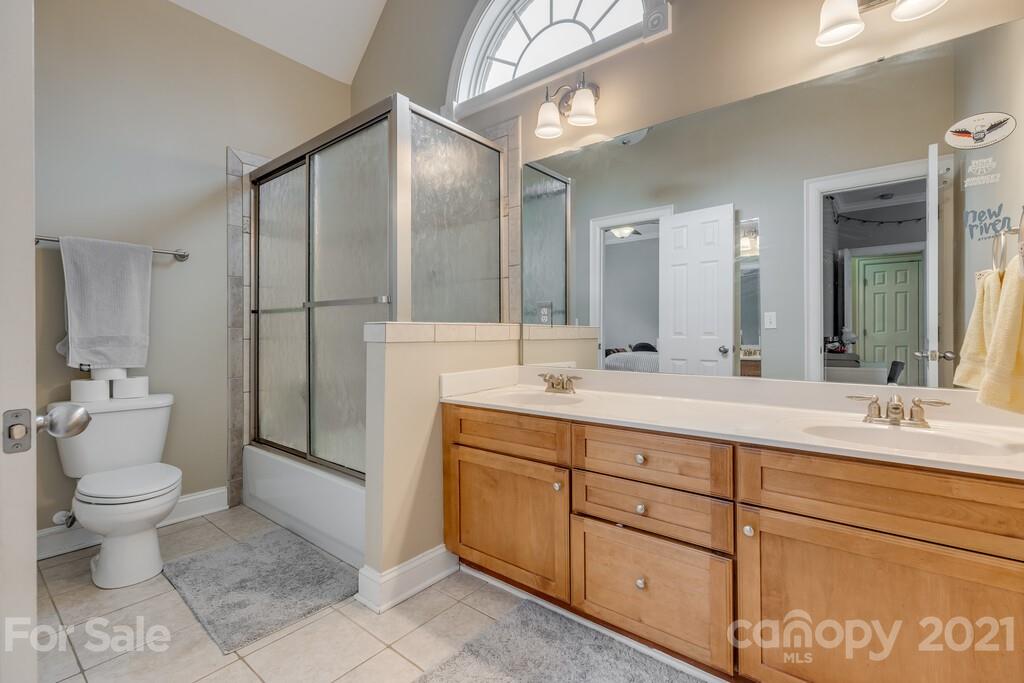 11155 Turtle Bay Court Tega Cay, SC 29708 - Photo 18 of 36 a bathroom with a double vanity sink toilet and a mirror