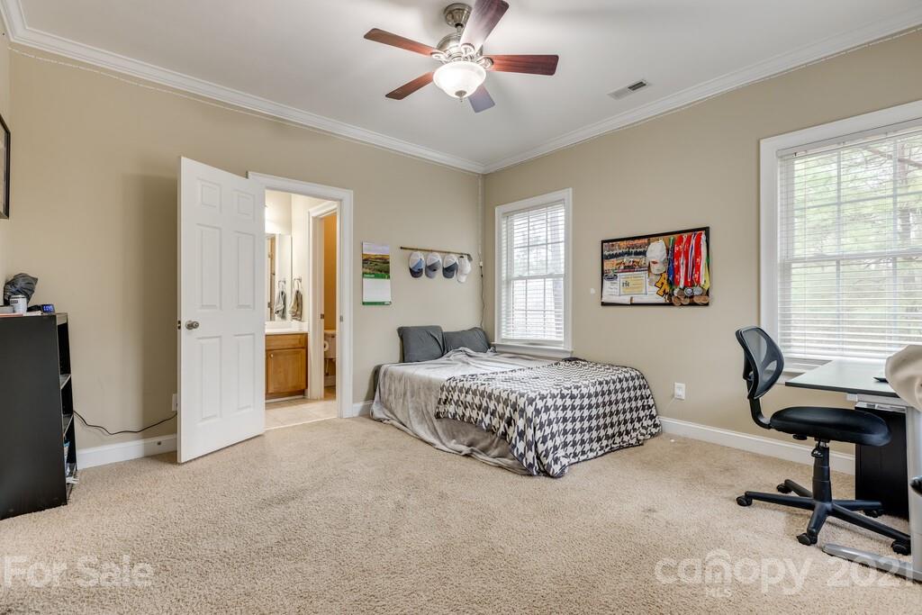 11155 Turtle Bay Court Tega Cay, SC 29708 - Photo 19 of 36 a spacious bedroom that has a bed and a desk in it