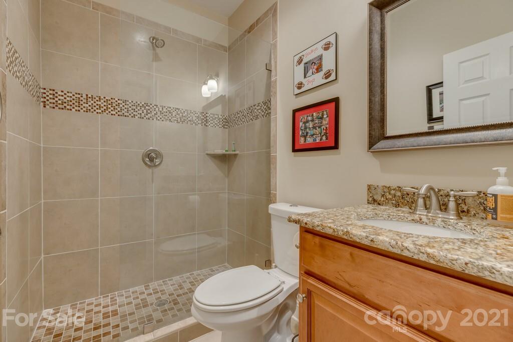 11155 Turtle Bay Court Tega Cay, SC 29708 - Photo 30 of 36 a bathroom with a granite countertop sink toilet and shower