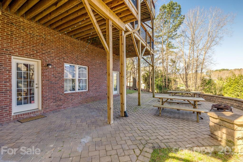 11155 Turtle Bay Court Tega Cay, SC 29708 - Photo 34 of 36 a building outdoor space with patio furniture and potted plants
