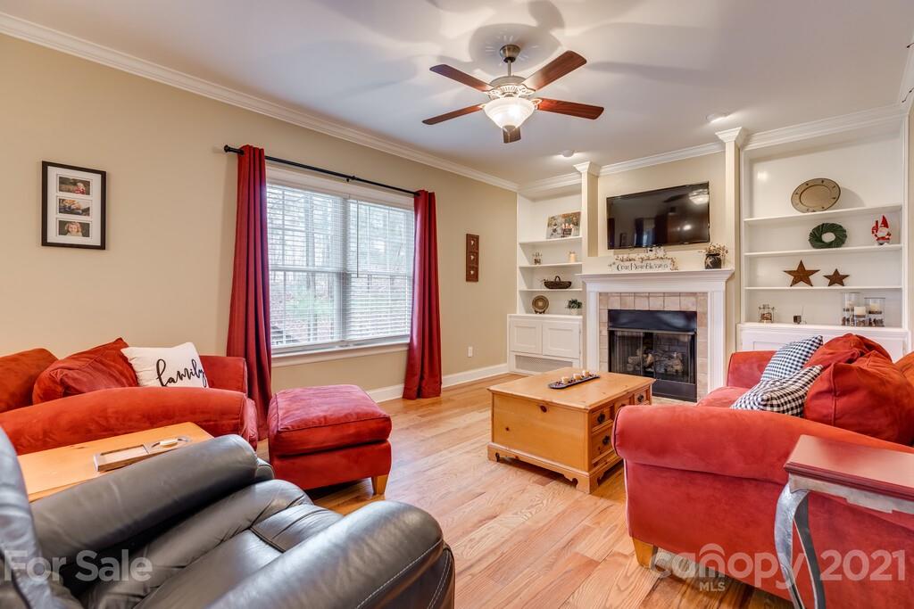 11155 Turtle Bay Court Tega Cay, SC 29708 - Photo 9 of 36 a living room with furniture a flat screen tv and a fireplace