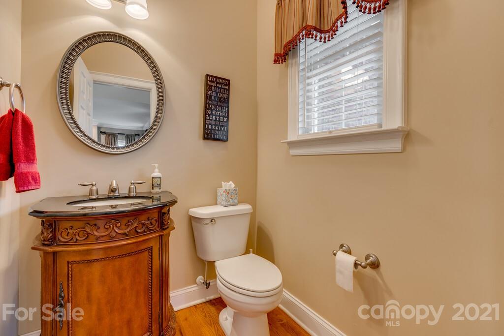 11155 Turtle Bay Court Tega Cay, SC 29708 - Photo 10 of 36 a bathroom with a toilet a sink and a mirror