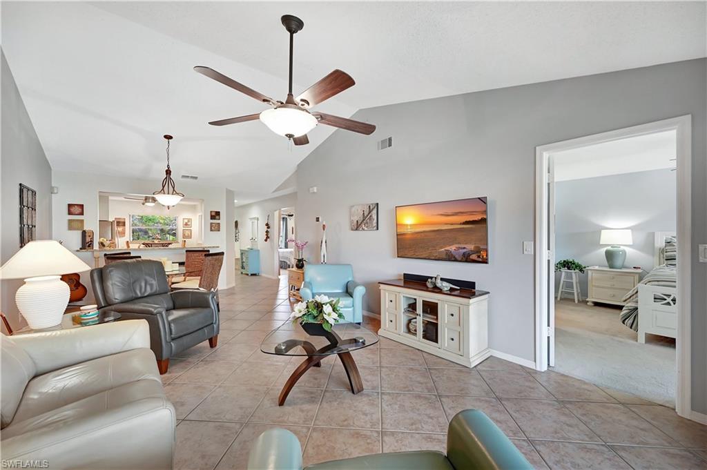 784 Landover Circle, Unit 203 Naples, FL 34104 - Photo 2 of 16 a living room with furniture and a flat screen tv