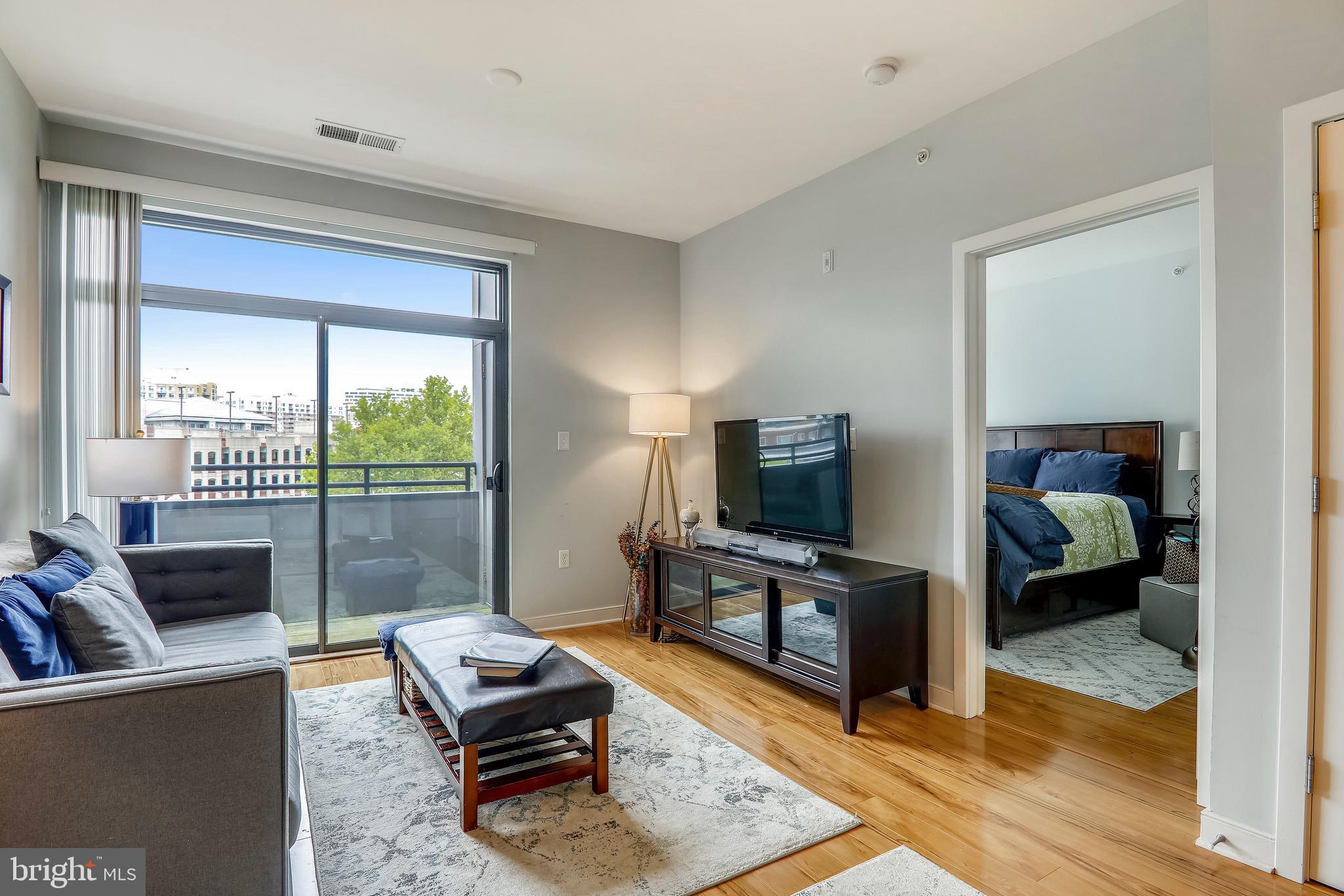 8005-13 13th Street, Unit 404 Silver Spring, MD 20910 - Photo 5 of 51 Living Room With a Large Sliding Door To Balcony