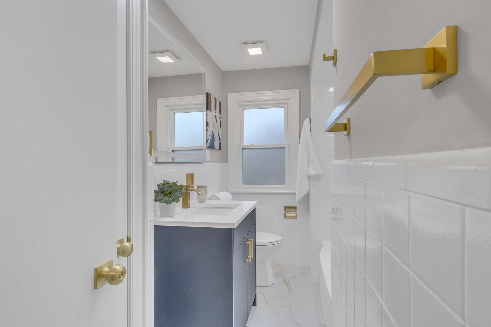 6304 North Troy Street Chicago, IL 60659 - Photo 16 of 35 a bathroom with a sink vanity and a mirror