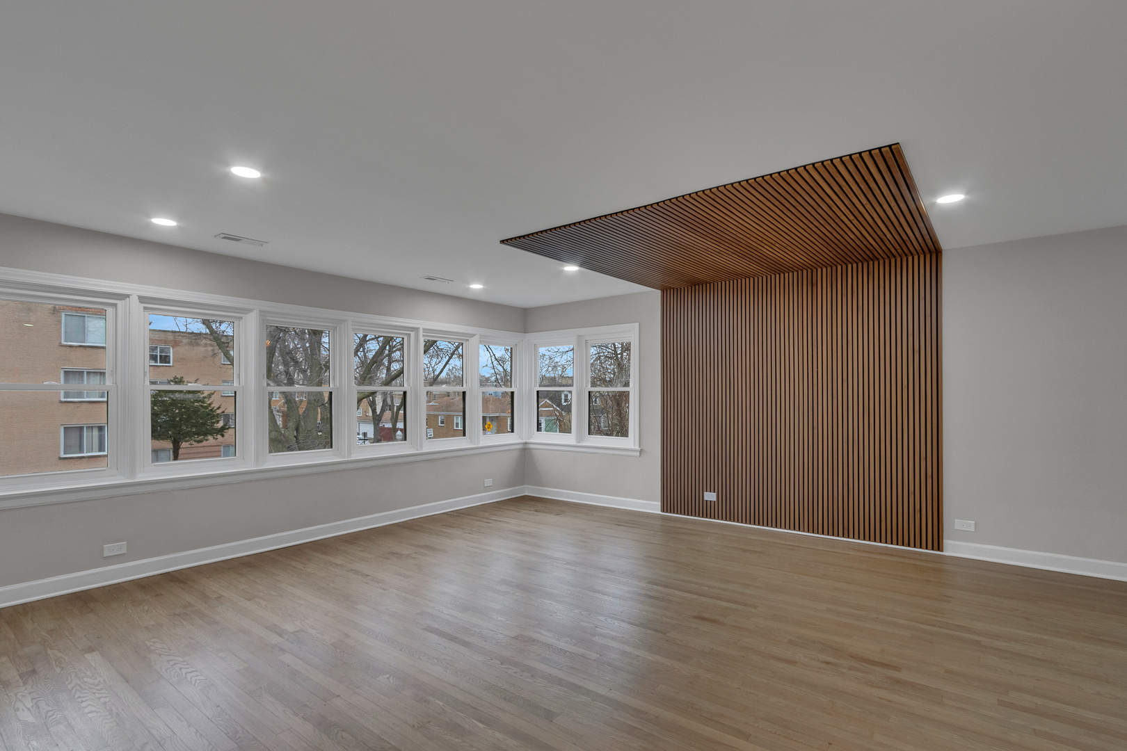 6304 North Troy Street Chicago, IL 60659 - Photo 19 of 35 a view of an empty room with wooden floor and a window