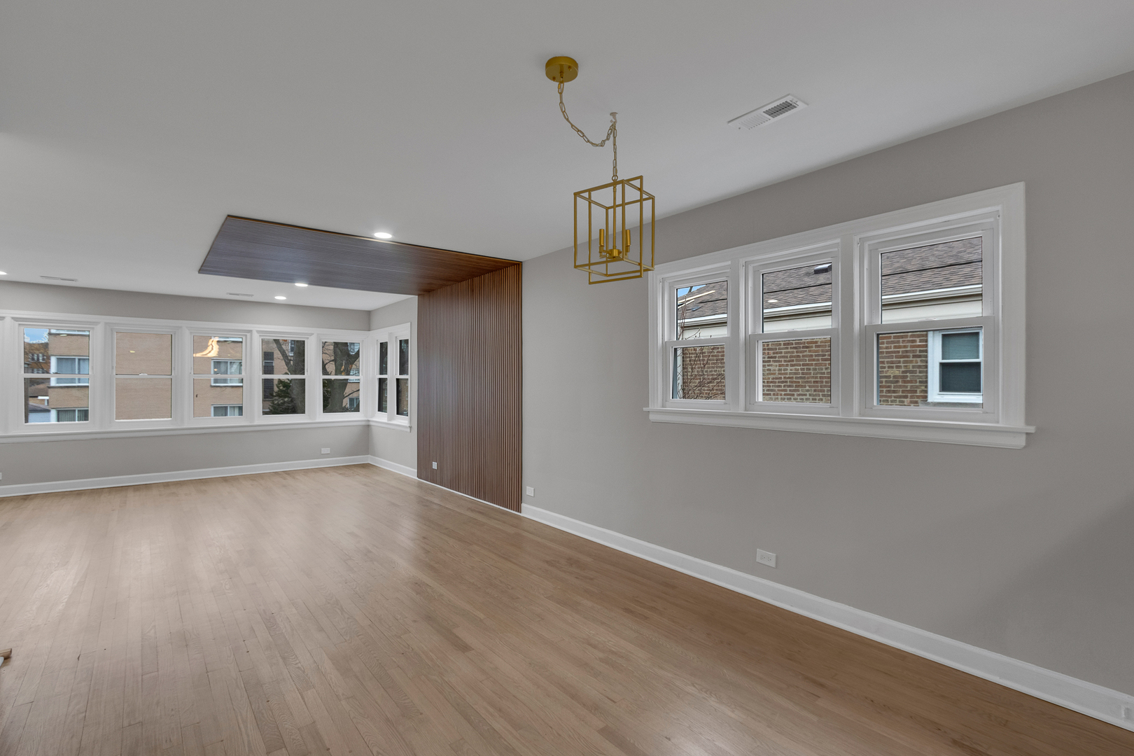 6304 North Troy Street Chicago, IL 60659 - Photo 22 of 35 a view of an empty room with wooden floor and a window